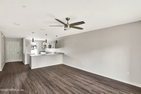a view of a kitchen with wooden floor and a sink