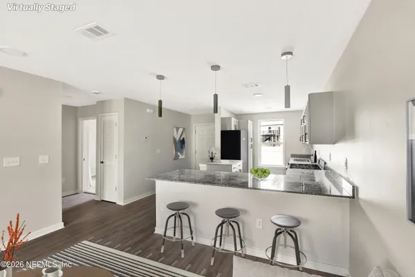 a kitchen with stainless steel appliances granite countertop a sink a stove and a refrigerator