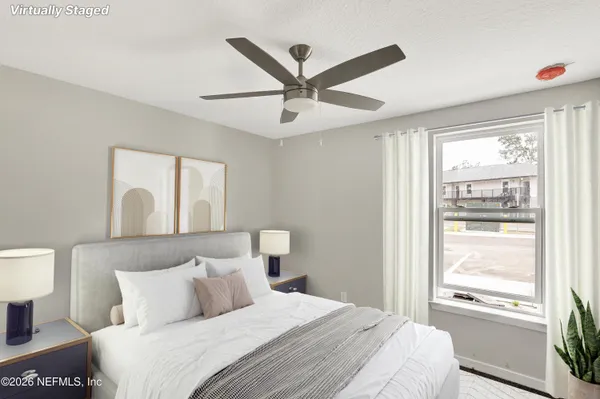 a bedroom with a large bed and a window