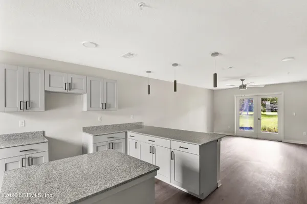 a kitchen with stainless steel appliances granite countertop a sink and a stove