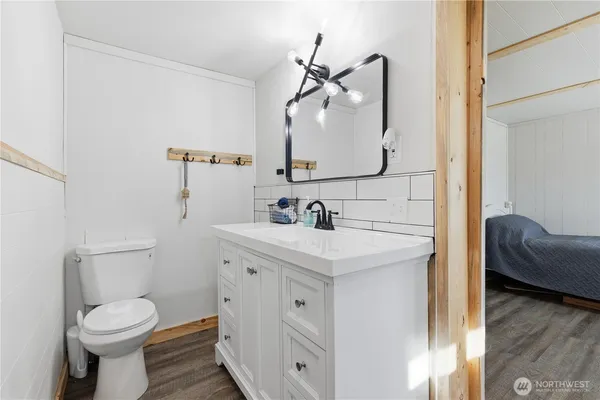 a bathroom with a toilet sink and mirror