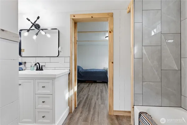 a en suite bathroom with a sink a mirror and a shower