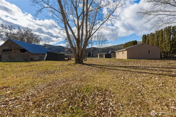 a backyard of a house with large trees