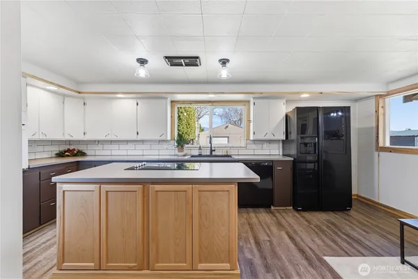a kitchen with a sink stove and refrigerator