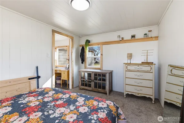 a bedroom with a bed and a television