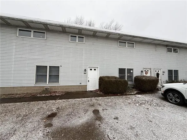 a front view of a house with parking space