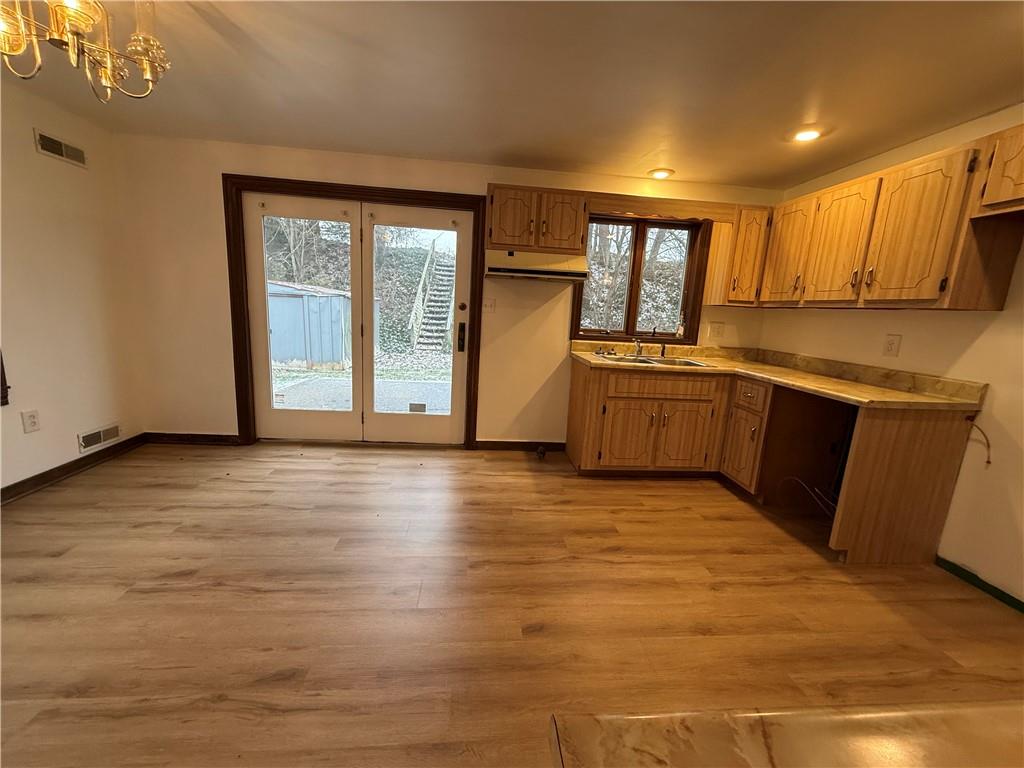 562 Bullcreek Road, Unit 562 Butler, PA 16002 - Photo 4 of 19 a large kitchen with stainless steel appliances granite countertop a sink and cabinets with wooden floor
