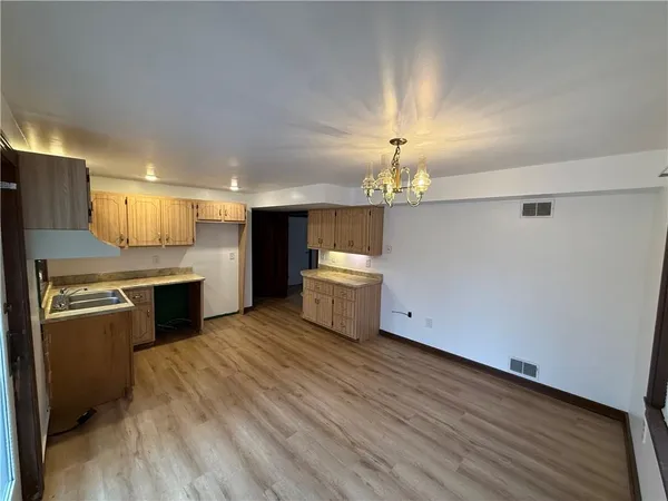 a kitchen with stainless steel appliances a kitchen island a stove and a refrigerator