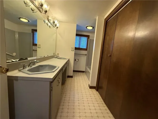 a bathroom with a sink a toilet a mirror and vanity