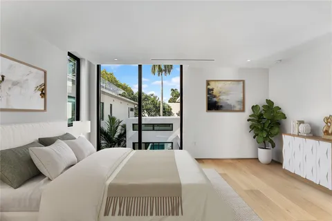 a bedroom with a bed and a painting on the wall