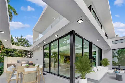 a view of a house with a yard and sitting area