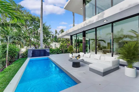 a view of a house with a yard and sitting area