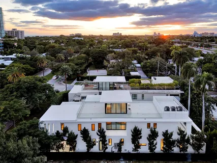 a view of a hallway with wooden floor and stairs