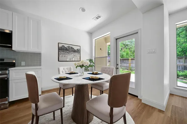 a view of a dining room with furniture window and wooden floor