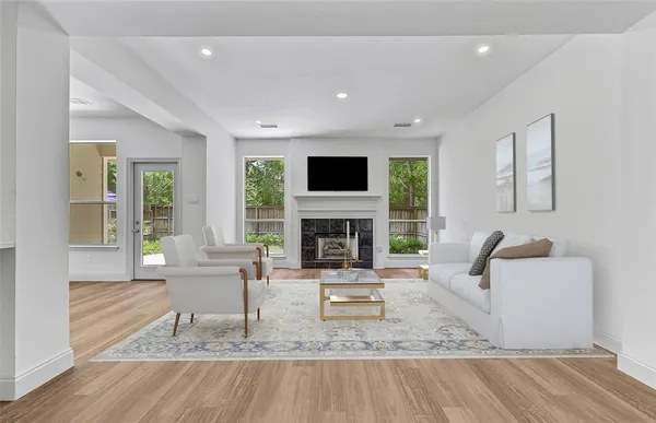 a living room with fireplace furniture and a flat screen tv