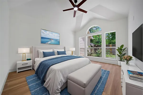 a spacious bedroom with a bed and a large window