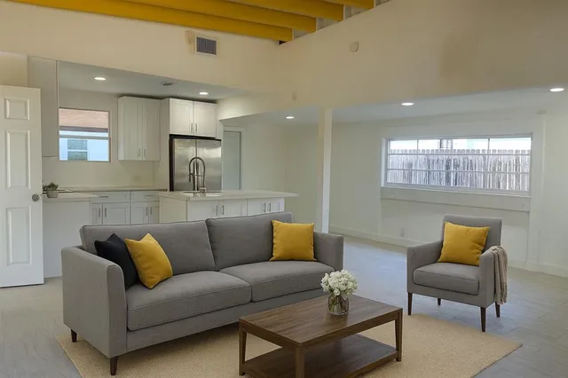 a living room with furniture and a glass door