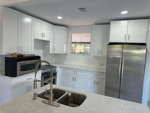 821 North B Street Lake Worth Beach, FL 33460 - Photo 7 of 9 a kitchen with a sink stainless steel appliances and cabinets