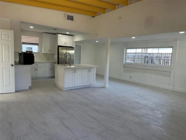 a view of kitchen cabinet and windows