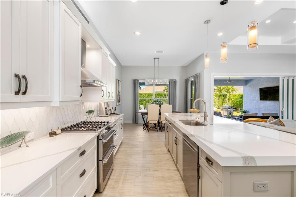 29 Johnnycake Drive Naples, FL 34110 - Photo 13 of 42 a kitchen with stove a sink and cabinets