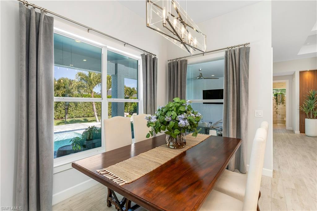 29 Johnnycake Drive Naples, FL 34110 - Photo 14 of 42 a living room with furniture and a potted plant