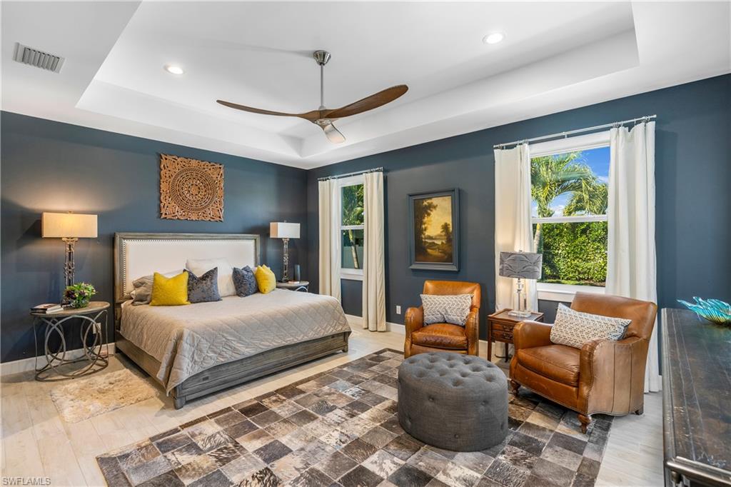 29 Johnnycake Drive Naples, FL 34110 - Photo 17 of 42 a bedroom with a bed and glass windows