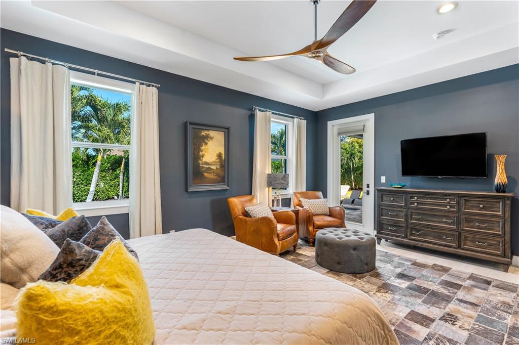 29 Johnnycake Drive Naples, FL 34110 - Photo 18 of 42 a bedroom with a bed and glass windows