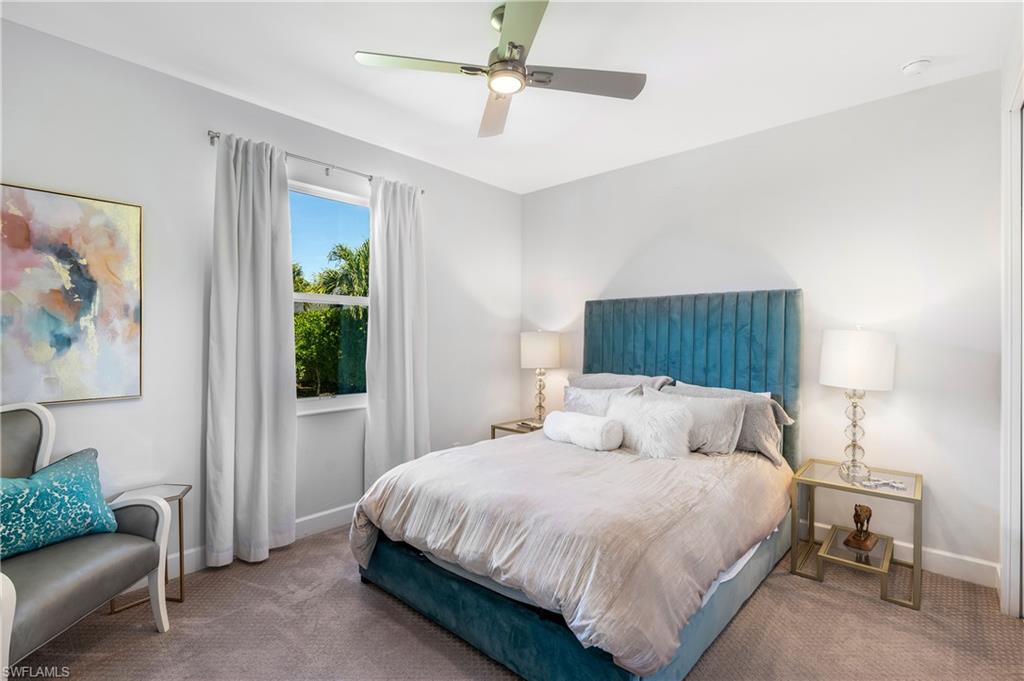 29 Johnnycake Drive Naples, FL 34110 - Photo 20 of 42 a bedroom with a bed couch and a window