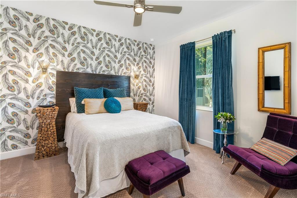 29 Johnnycake Drive Naples, FL 34110 - Photo 24 of 42 a bedroom with a bed and wooden floor