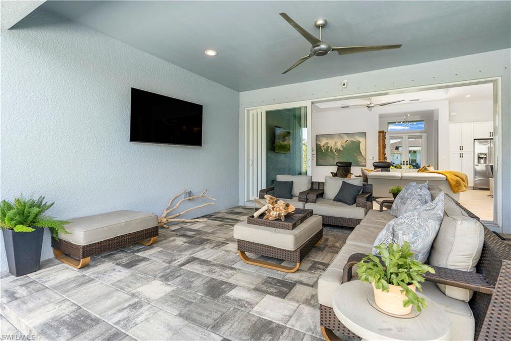29 Johnnycake Drive Naples, FL 34110 - Photo 27 of 42 a living room with furniture and a flat screen tv