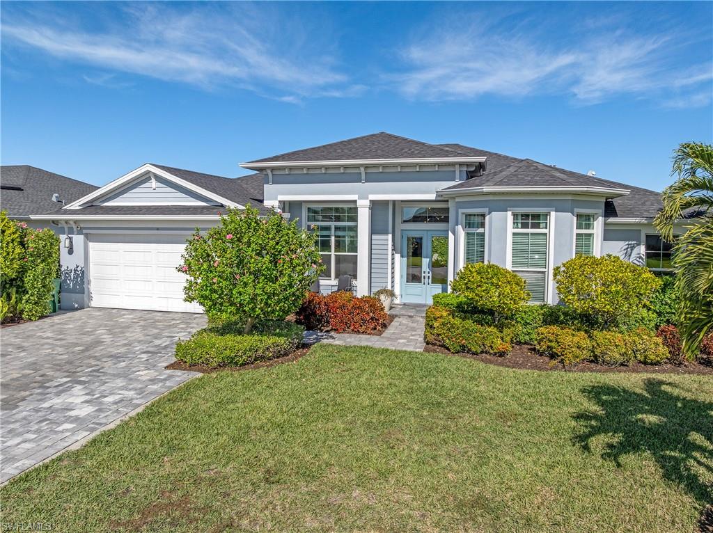 29 Johnnycake Drive Naples, FL 34110 - Photo 41 of 42 a front view of a house with a yard