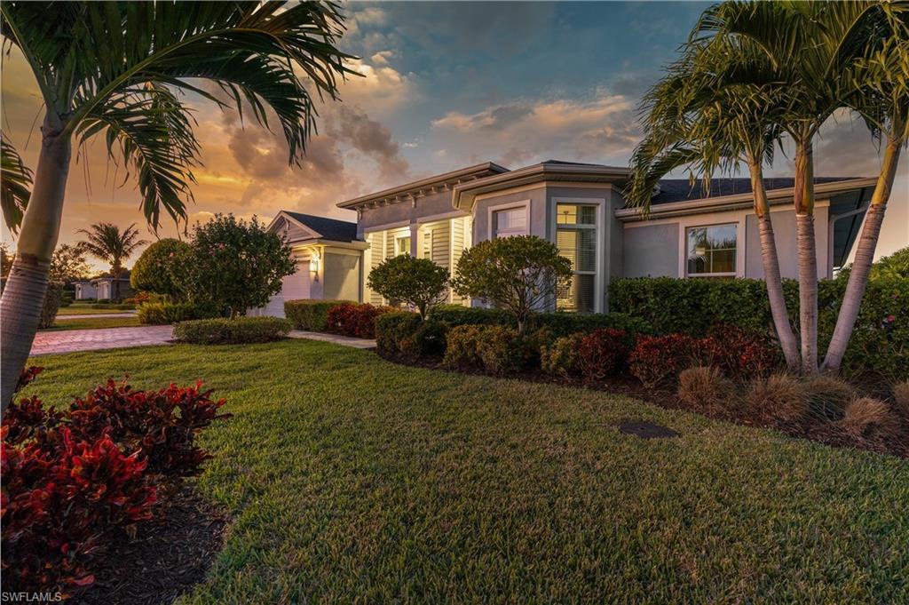 29 Johnnycake Drive Naples, FL 34110 - Photo 42 of 42 a view of a house with a yard and potted plants