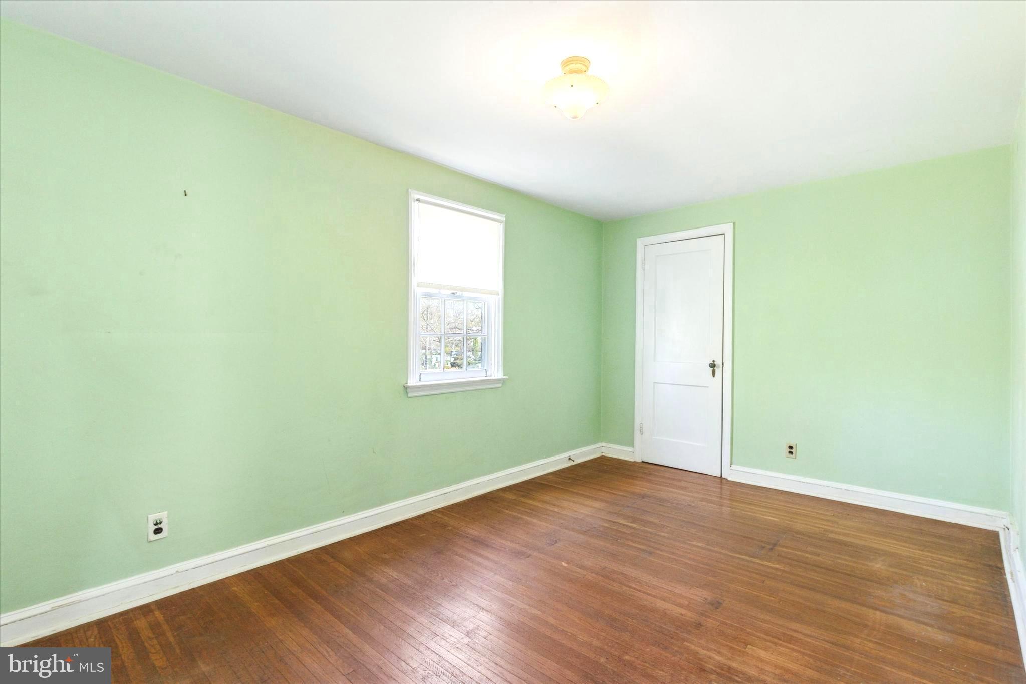 219 Williamsburg Road Ardmore, PA 19003 - Photo 13 of 14 an empty room with wooden floor and window