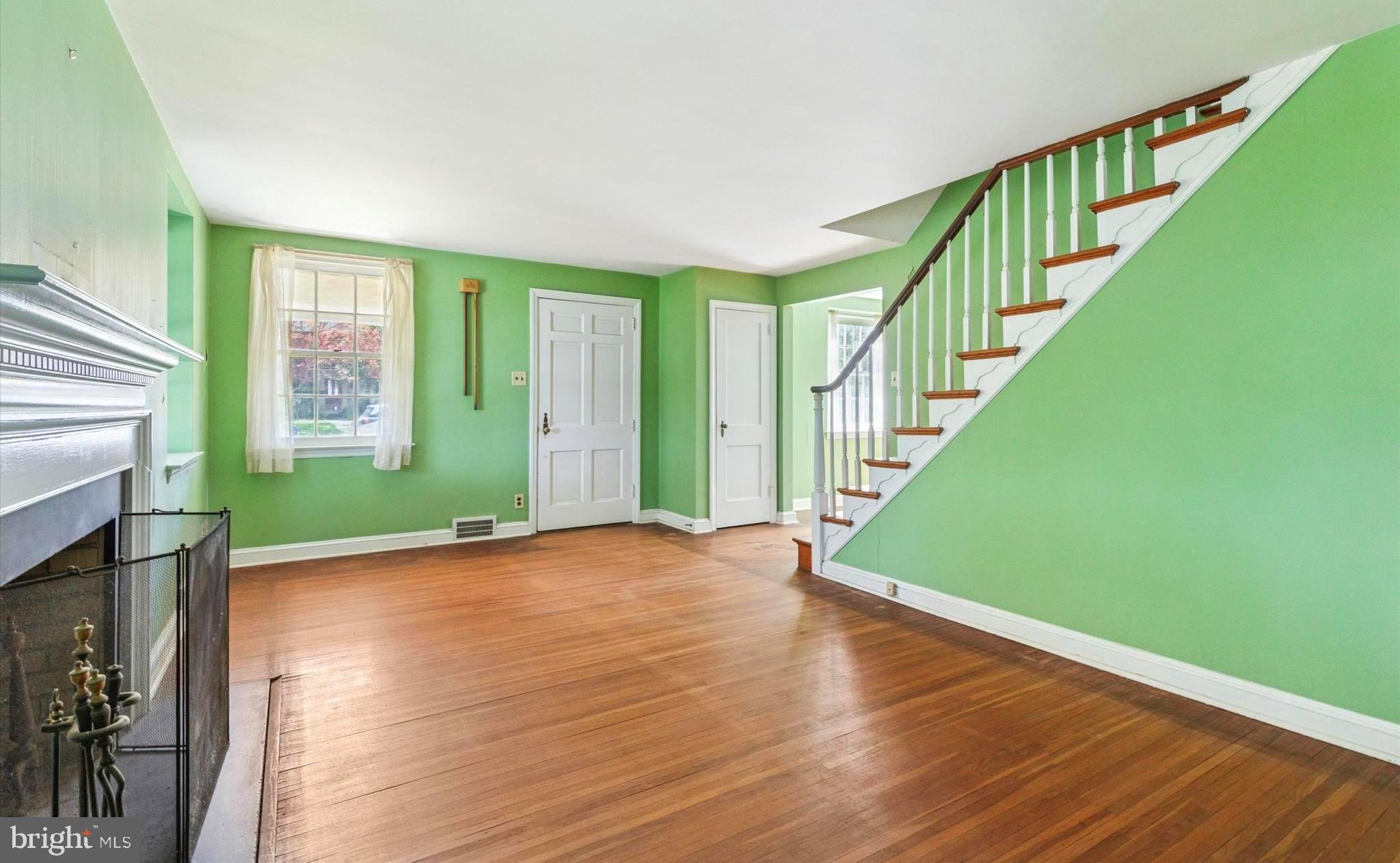 219 Williamsburg Road Ardmore, PA 19003 - Photo 5 of 14 a view of an room with wooden floor windows and a fireplace