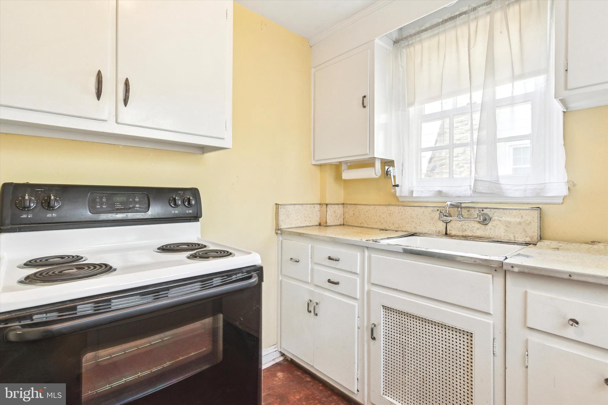 219 Williamsburg Road Ardmore, PA 19003 - Photo 7 of 14 a kitchen with granite countertop white cabinets and a stove