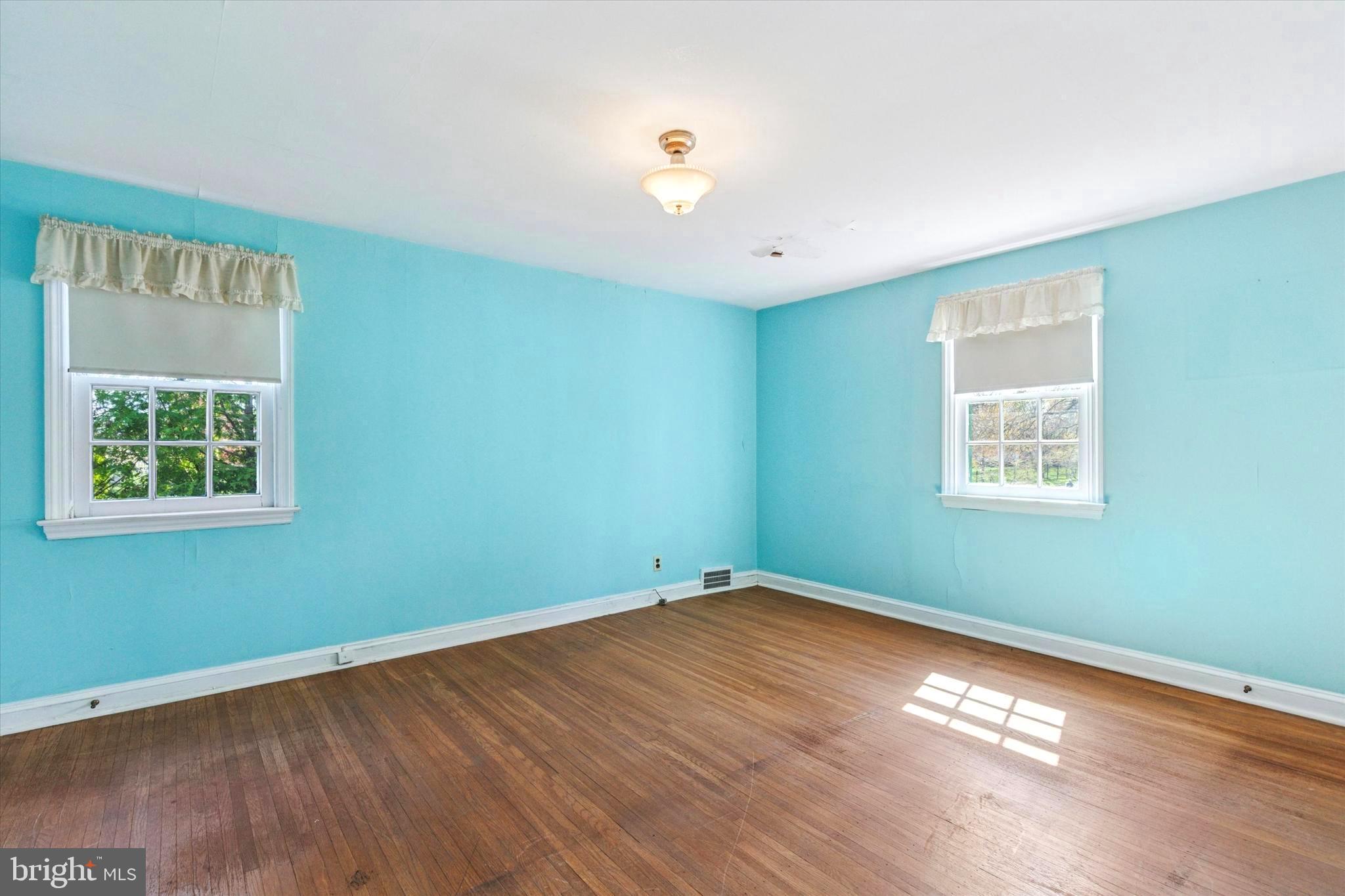219 Williamsburg Road Ardmore, PA 19003 - Photo 9 of 14 a view of a room with wooden floor and windows