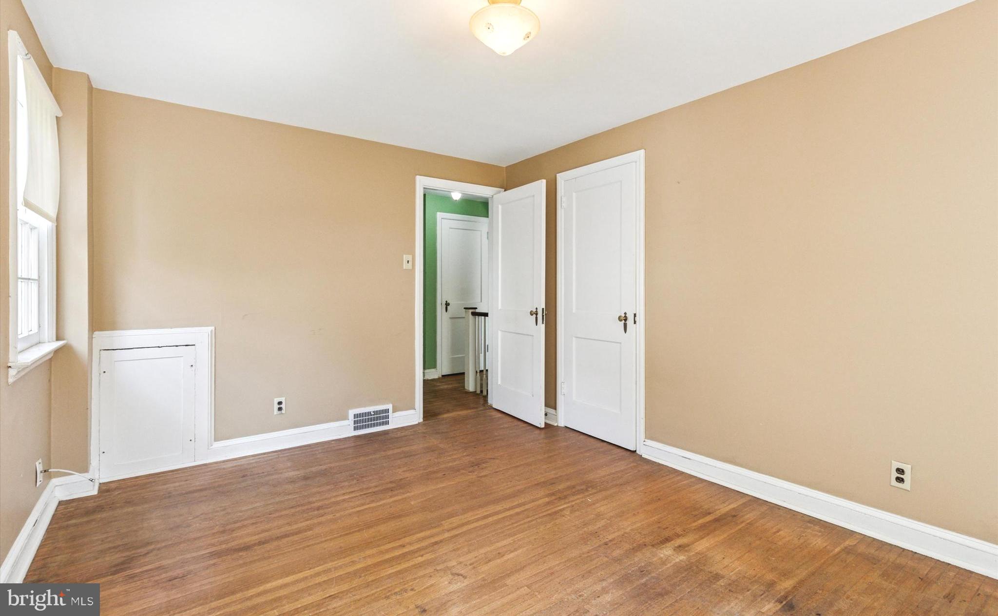 219 Williamsburg Road Ardmore, PA 19003 - Photo 10 of 14 an empty room with wooden floor and windows