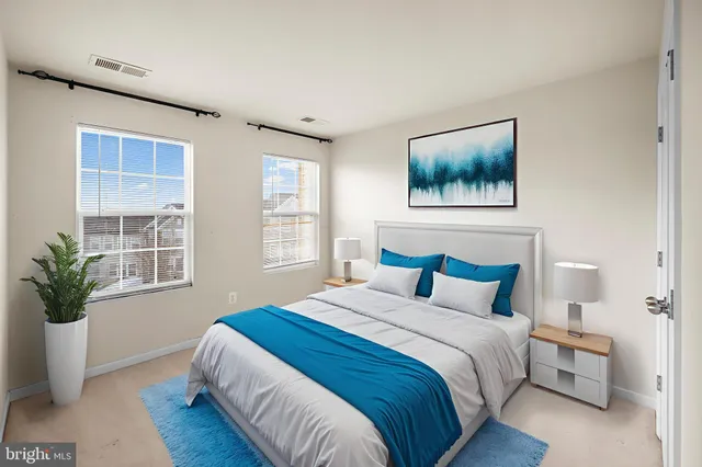 a bedroom with bed and a potted plant