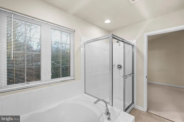 a bathroom with a bathtub and a window