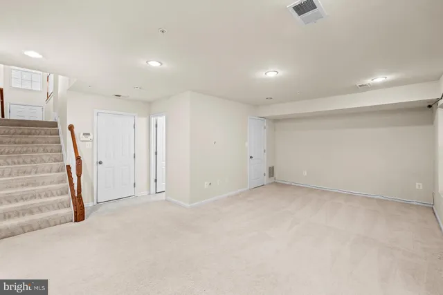 an empty room with a staircase and a projector