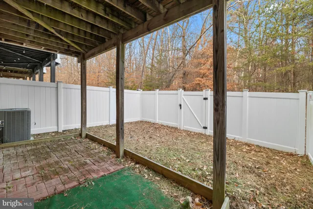 a view of balcony with wooden floor and fence