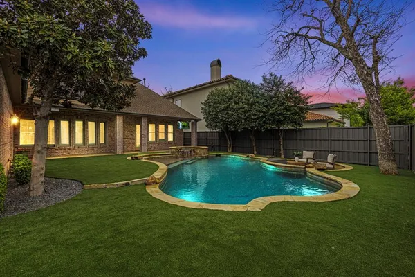 a view of a house with a backyard
