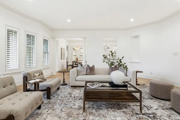 a living room with furniture potted plant and a window