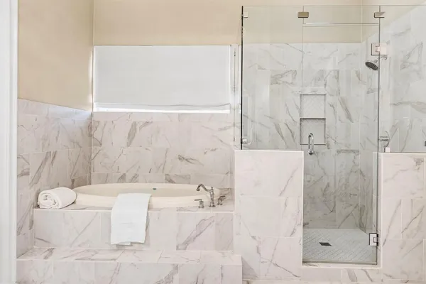 a bathroom with a bathtub and shower