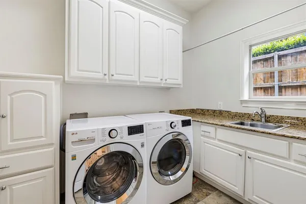 a utility room with sink dryer and washer
