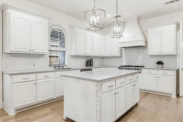 a kitchen with white cabinets and white appliances