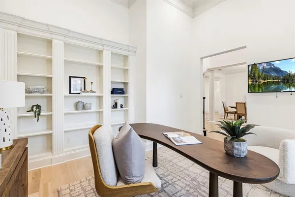 a view of a dining room with furniture and a potted plant