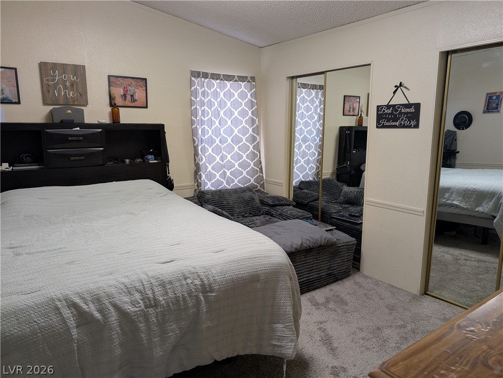 320 6th Street Panaca, NV 89042 - Photo 15 of 30 Bedroom with light carpet and mirrored closet doors