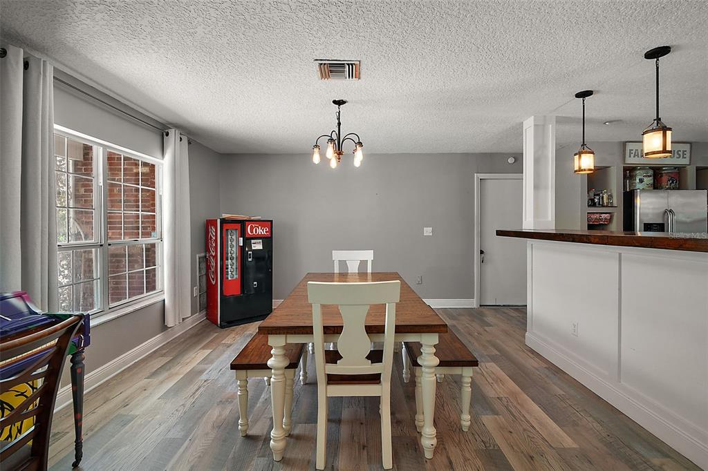 705 West Summit Court Mount Dora, FL 32757 - Photo 14 of 37 a view of a dining room with furniture and a chandelier