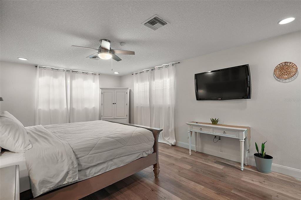 705 West Summit Court Mount Dora, FL 32757 - Photo 15 of 37 a bedroom with a bed and a flat screen tv